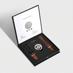 Watch set with two straps in a TOMI box on a light gray background