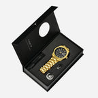 Gold watch with black face and additional accessories in a black box on a white background
