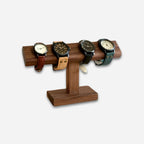 Wooden watch stand with four watches on a white background