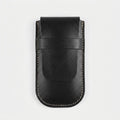 A black leather card holder or wallet with light beige contrast stitching, shown flat against a light gray background.