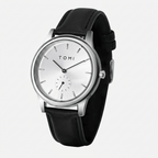 Black wristwatch with a silver case and white face on a light gray background
