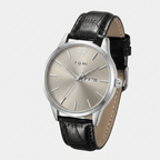 Watch with black leather strap and silver dial on a white background