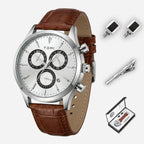 Brown leather watch with silver case, cufflinks, and tie clip on a white background