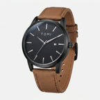 Watch with brown strap and black dial on a white background