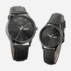 Two black watches with leather straps on a white background