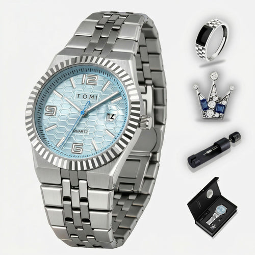 Silver watch with blue face, ring, crown, and pen on a white background