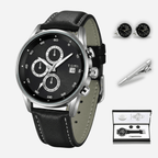 Black leather watch with silver accents, cufflinks, and pen on a white background