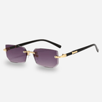 Sunglasses with gold frames and purple lenses on a light gray background