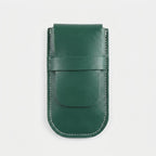 A dark green leather card holder or phone pouch with white contrast stitching, shown flat against a light gray background.
