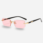 Sunglasses with pink lenses and gold frames on a white background