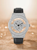 Luxury watch with black leather strap and silver case on a blurred background