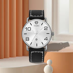 Black wristwatch with silver case on a neutral background
