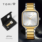 Gold and silver watch with gift box and brooch & ring on a black background, featuring the TOMI brand.