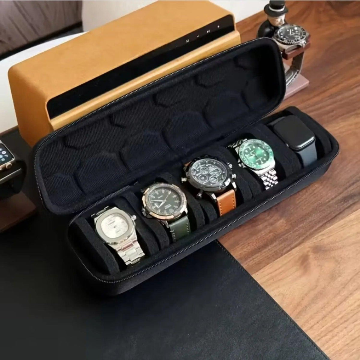Black watch case with six watches on a wooden surface