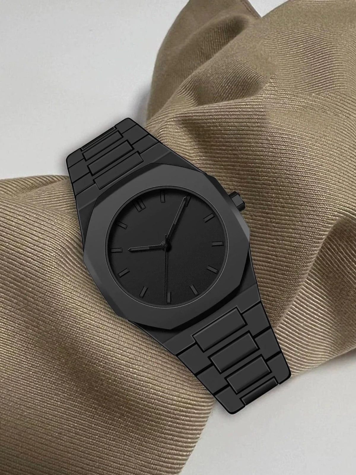 Black watch on a textured beige fabric background