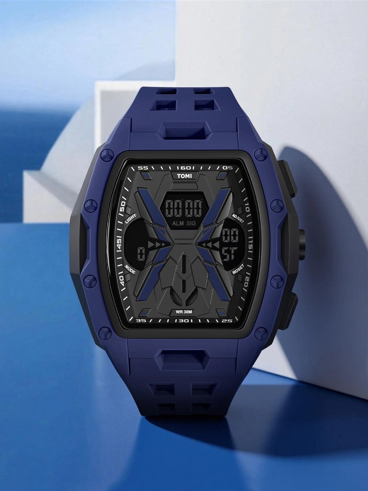 A rugged digital watch with a dark blue silicone strap and a black and blue geometric face, displayed on a blue and white geometric background.