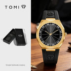 Tomi men's watch with a brushed gold-tone case, black dial, and black rubber strap, shown alongside its black presentation box on a light gray background.