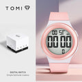 Digital watch with pink strap and white display on a light gray background, featuring the brand 'TOMI'.