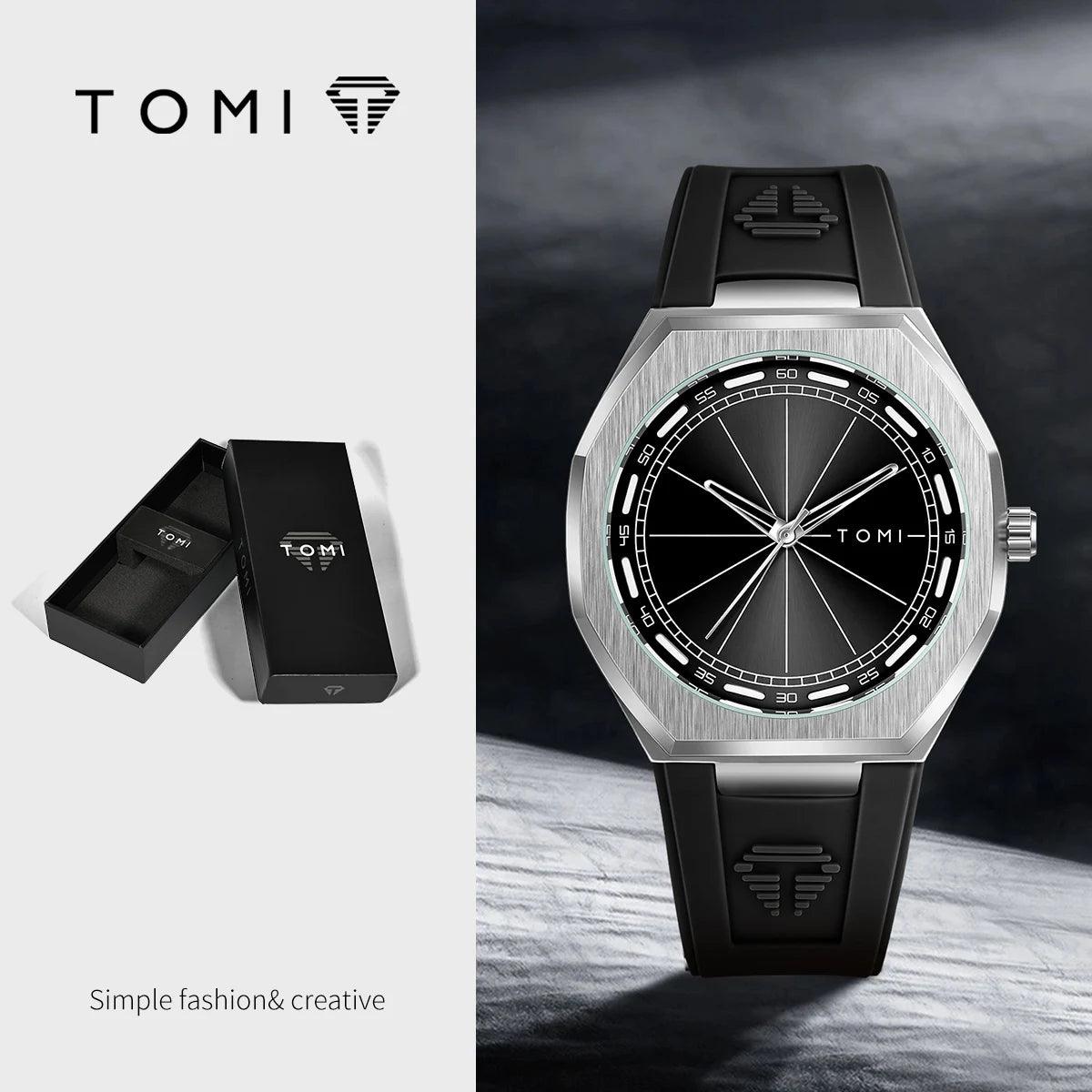 TOMI analog watch with a brushed silver-tone octagonal case, black dial, and black rubber strap, shown alongside its black presentation box on a split light gray background.