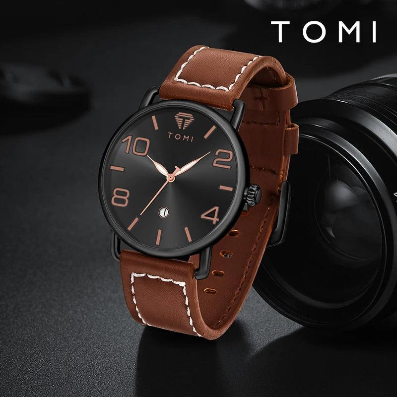 Brown leather watch with black dial on a dark background, featuring the brand 'TOMI'.