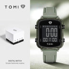 Digital watch with green strap and TOMI branding on a light gray background