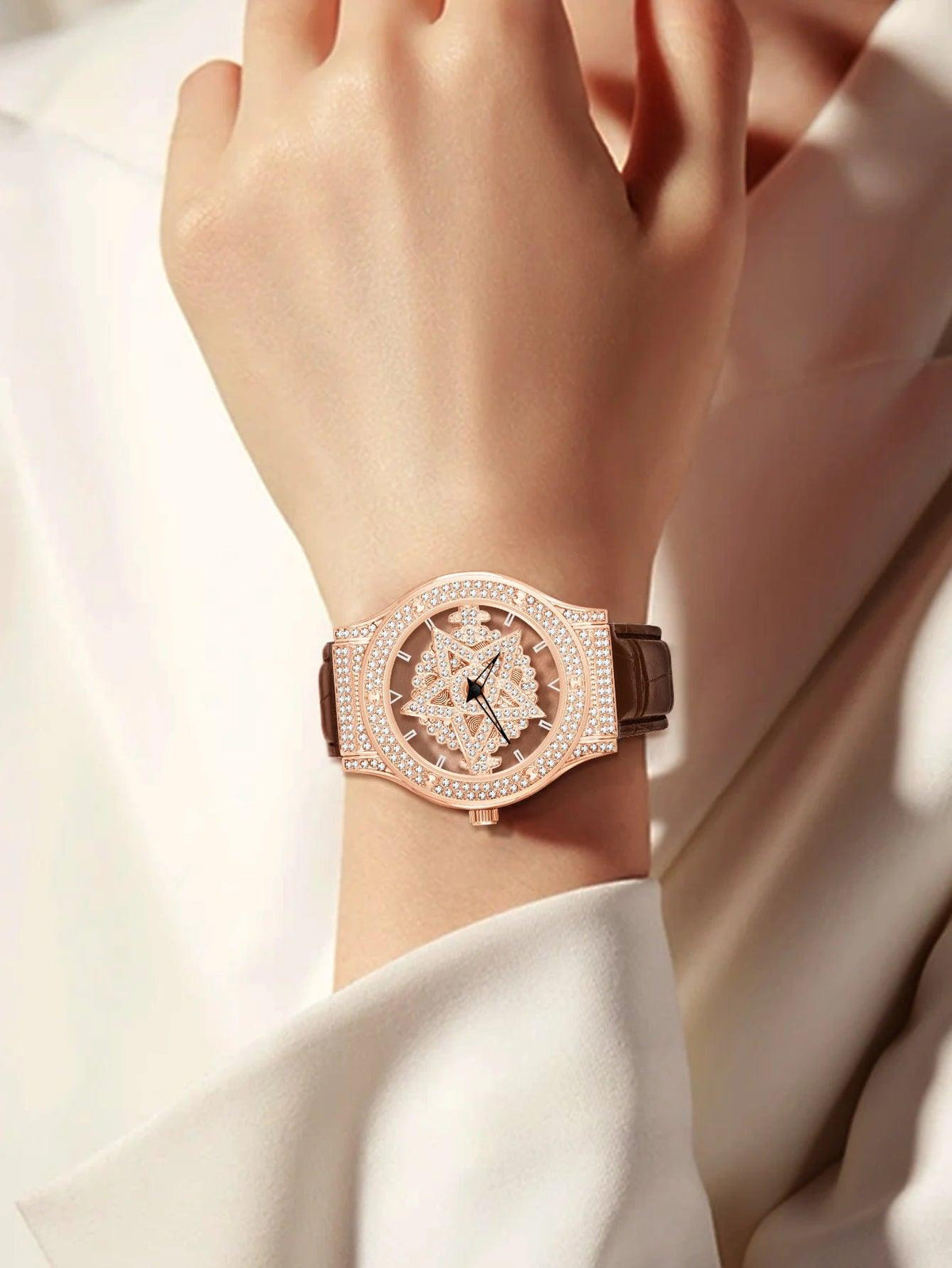 Rose gold watch on a wrist with a soft focus background