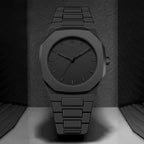 Black watch with a textured strap on a dark background