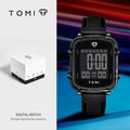 Black digital watch with TOMI branding on a blue and red gradient background