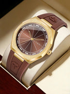 A luxury wristwatch with a brushed gold-tone octagonal case, a brown sunburst dial, and a matching brown rubber strap, presented inside a cream-colored watch box.