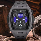 A rugged digital watch with a dark gray and black case and strap, featuring a blue display screen, set against a rocky desert background.