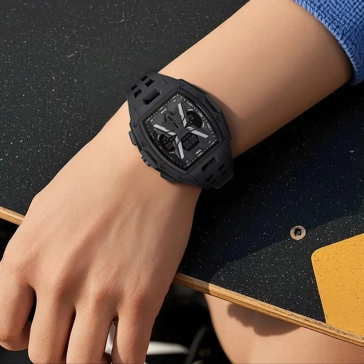 A black rugged sports watch with a digital display and analog face, worn on a person's wrist against a dark textured tabletop.