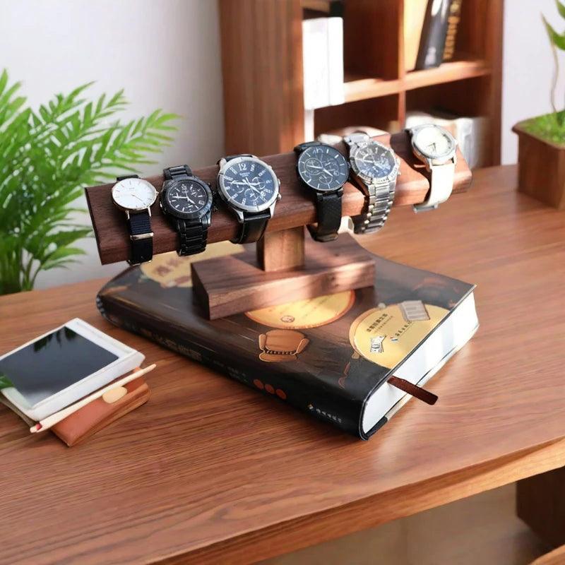 Wooden watch stand with six watches on a wooden table.