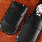 Black leather pouches on a brown leather background