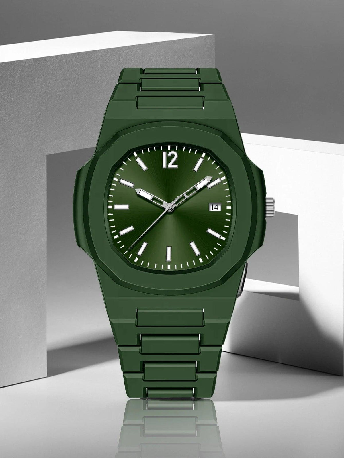 A green analog watch with a matching green link bracelet, a dark green dial, and silver-tone hands and markers, displayed on a modern gray and white geometric background.