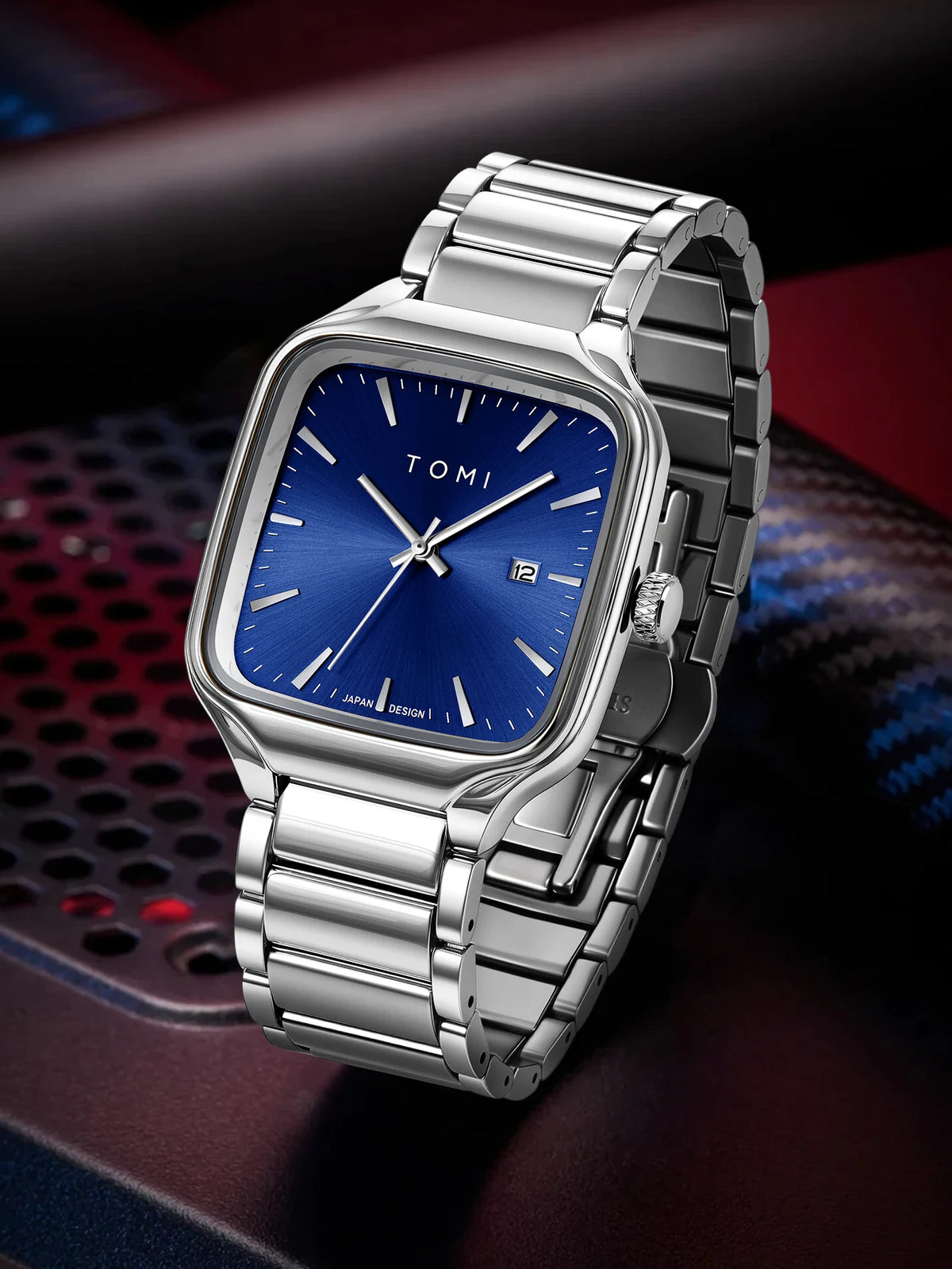 Silver watch with blue face on a dark background