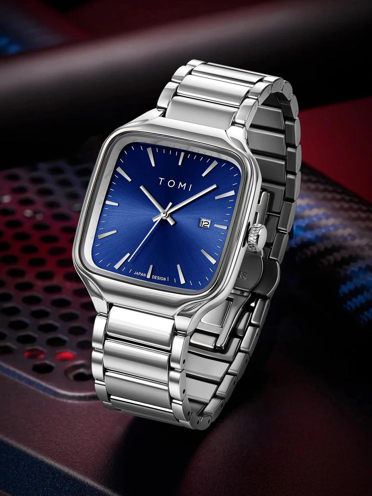 Silver watch with blue face on a dark background