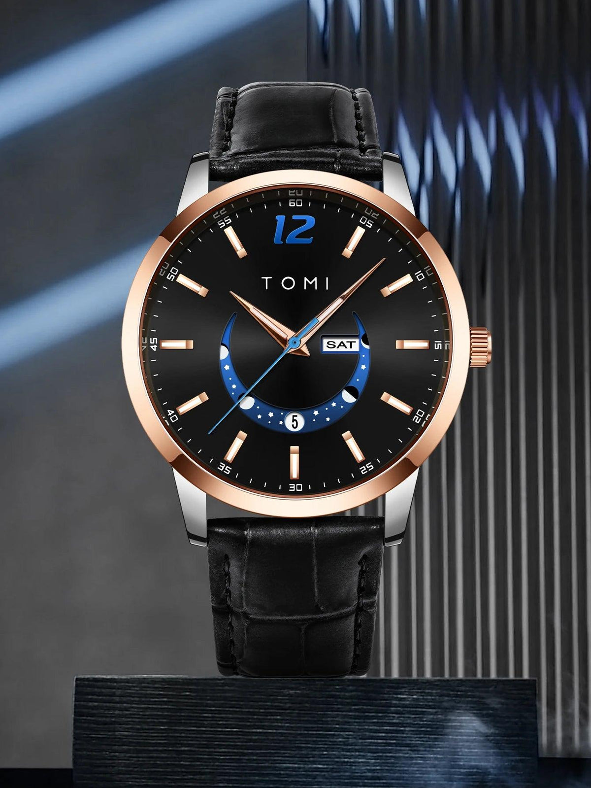 Black wristwatch with rose gold case and black leather strap on a dark background