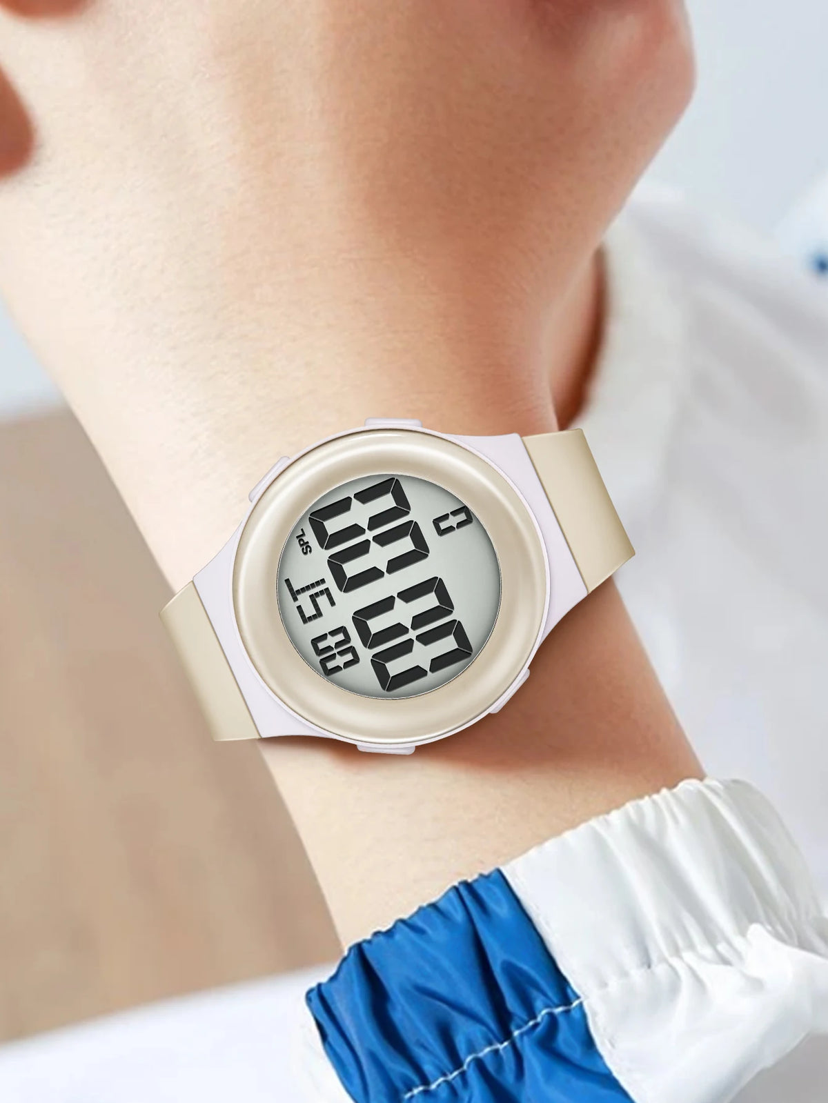 Digital watch on a wrist with a white strap