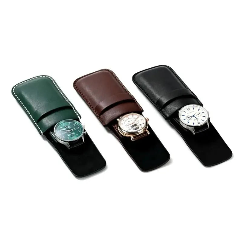 Three watch cases in green, brown, and black with watches inside on a white background