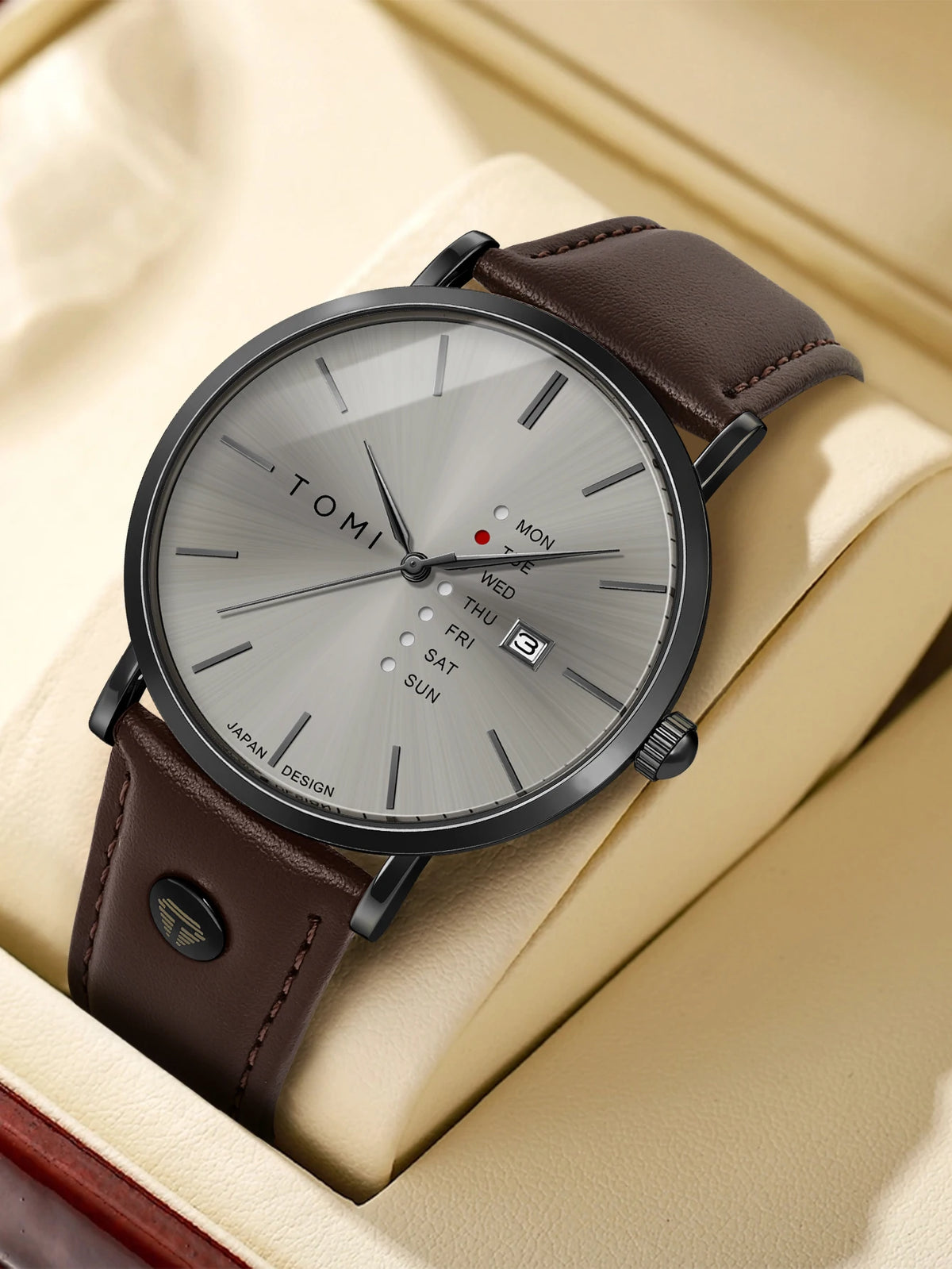 Tomi watch with brown leather strap on beige fabric background