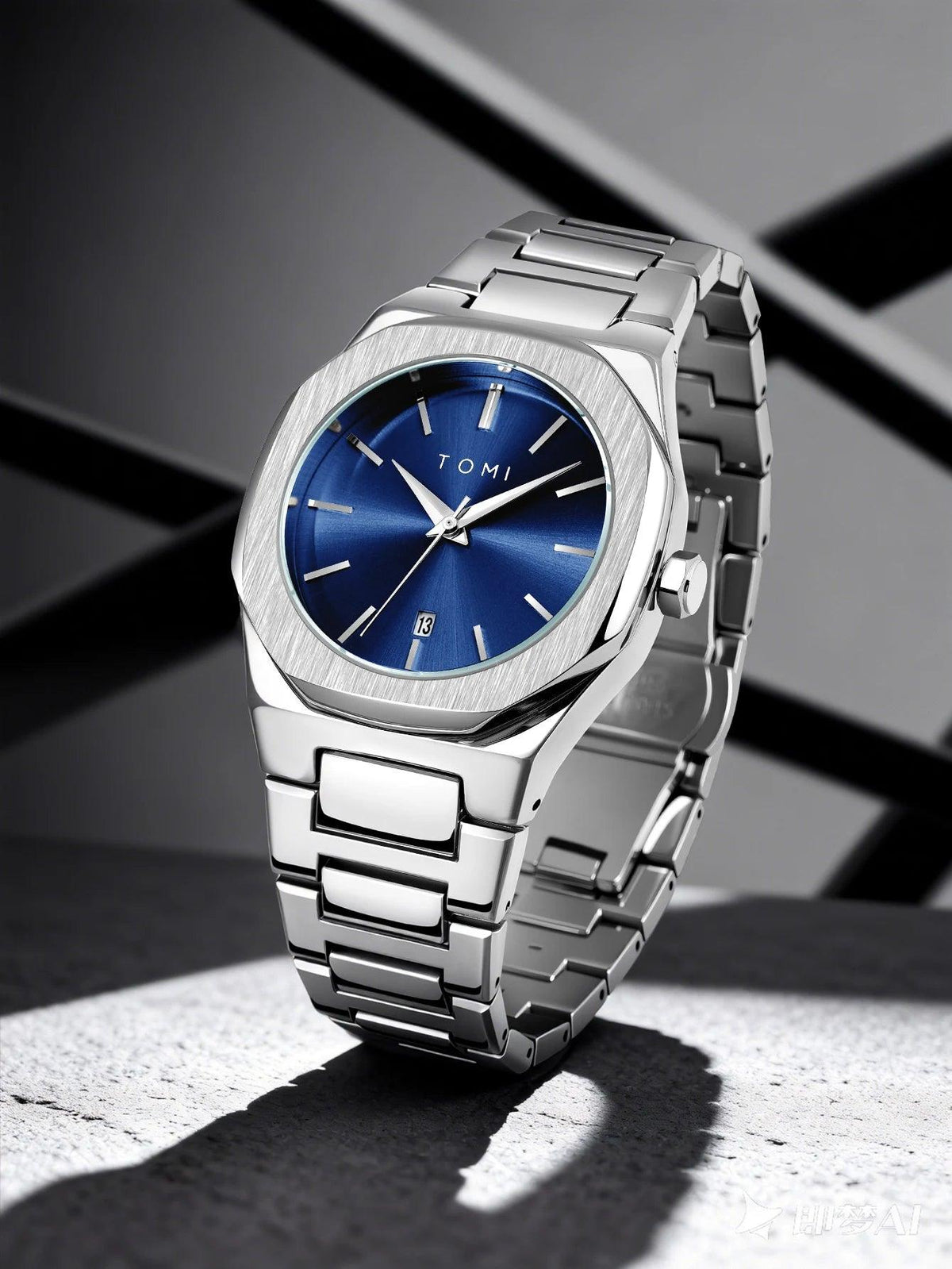 A Tumi stainless steel wristwatch with a blue sunburst dial, standing on a textured gray surface with dramatic shadows against a dark gray background.