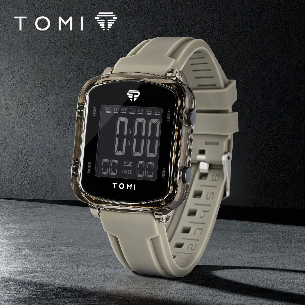 Digital watch with beige strap on a dark background, featuring the TOMI brand.