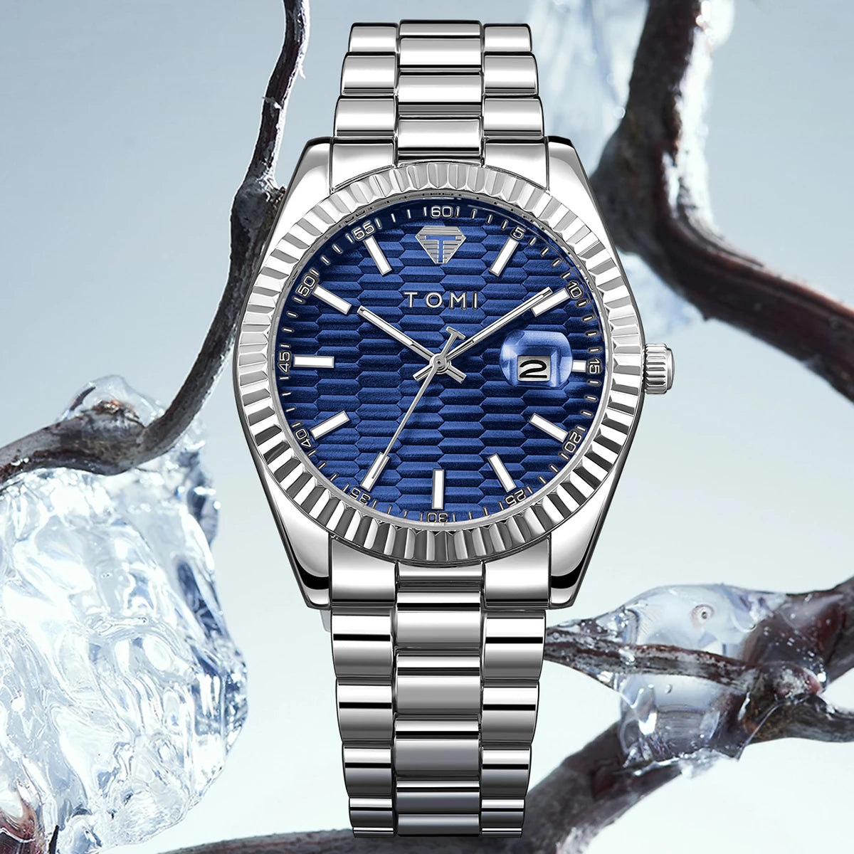 Silver watch with blue face on a branch and ice background