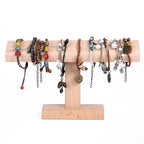 Wooden bracelet holder with various bracelets on a white background