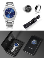 TOMI men's watch gift set featuring a stainless steel wristwatch with a blue dial, a silver-toned ring, a black cylindrical accessory, and black presentation packaging on a dark gray background.