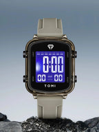 Digital watch with a gray strap on a rocky surface