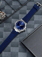 TOMI T051 blue dial watch flat lay on dark background