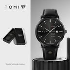 Black watch with leather strap and 'TOMI' branding on a gray background