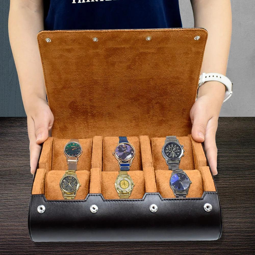 Open brown watch case with five watches displayed on a wooden surface.