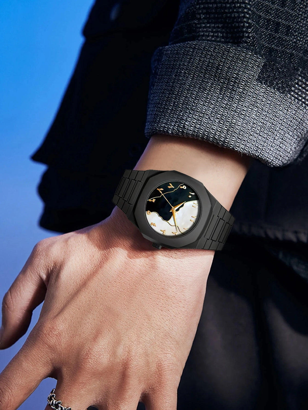 Black watch on a wrist with a blue background